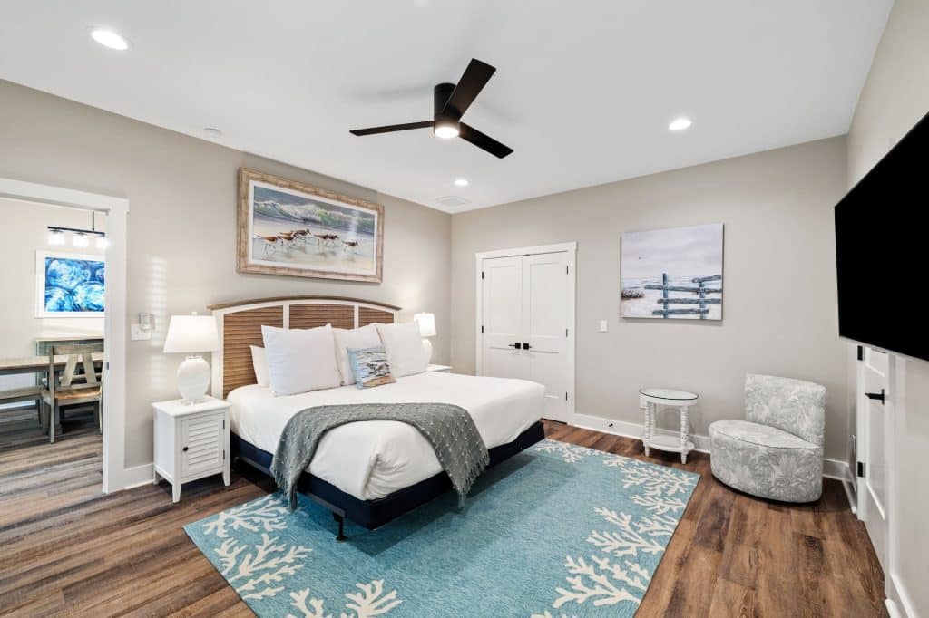coastal designed master bedroom with beachy white and blue furniture and accessories designed and decorated by Shore House Furniture in Panama City Beach Florida