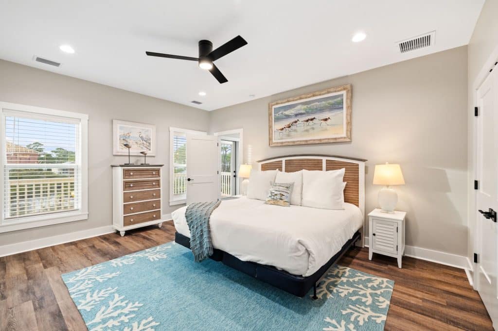 coastal designed master bedroom with beachy white and blue furniture and accessories designed and decorated by Shore House Furniture in Panama City Beach Florida