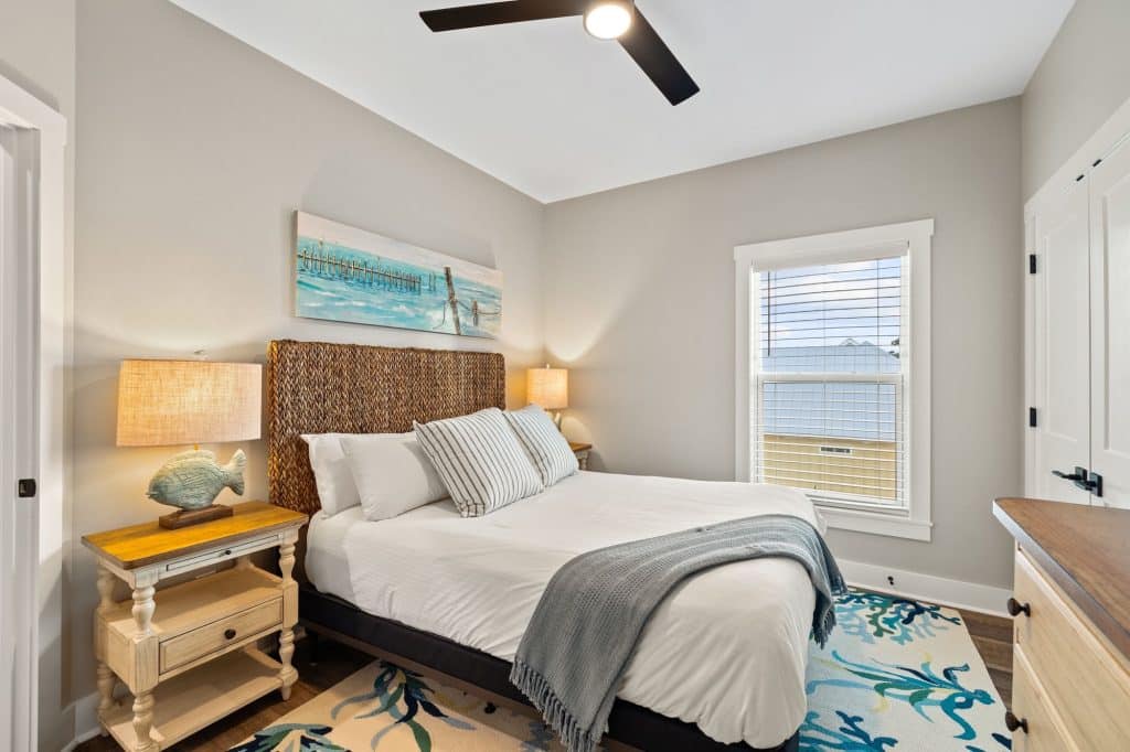 coastal designed guest bedroom with beachy white and blue furniture and accessories designed and decorated by Shore House Furniture in Panama City Beach Florida