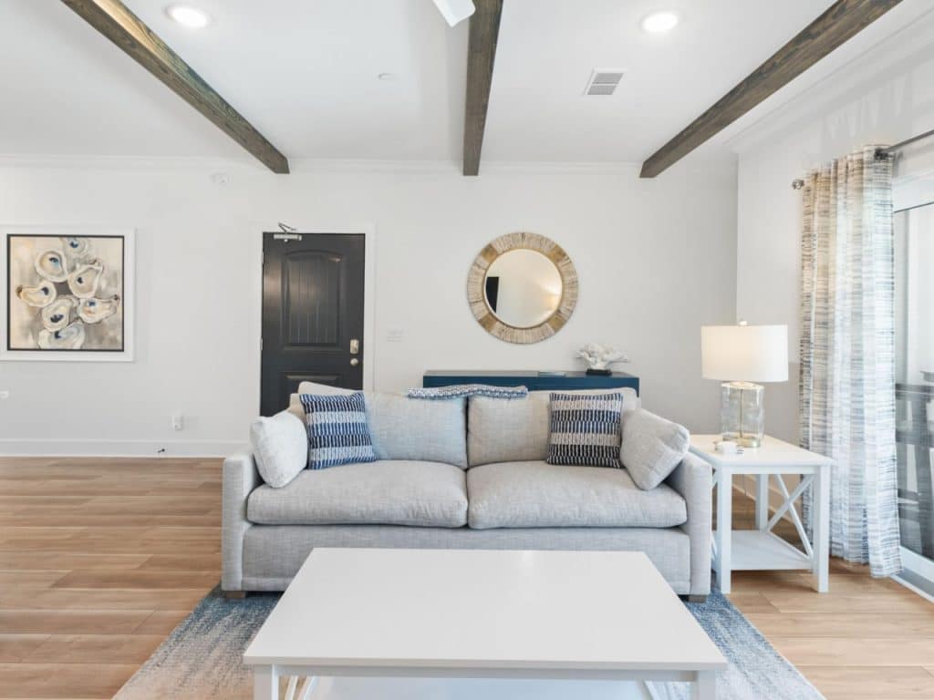 coastal designed sitting area inside a home with beachy white and dark blue accessories designed and decorated by Shore House Furniture in Panama City Beach Florida