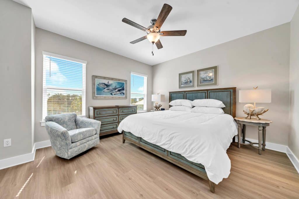 coastal designed master bedroom with beachy white accessories designed and decorated by Shore House Furniture in Panama City Beach Florida