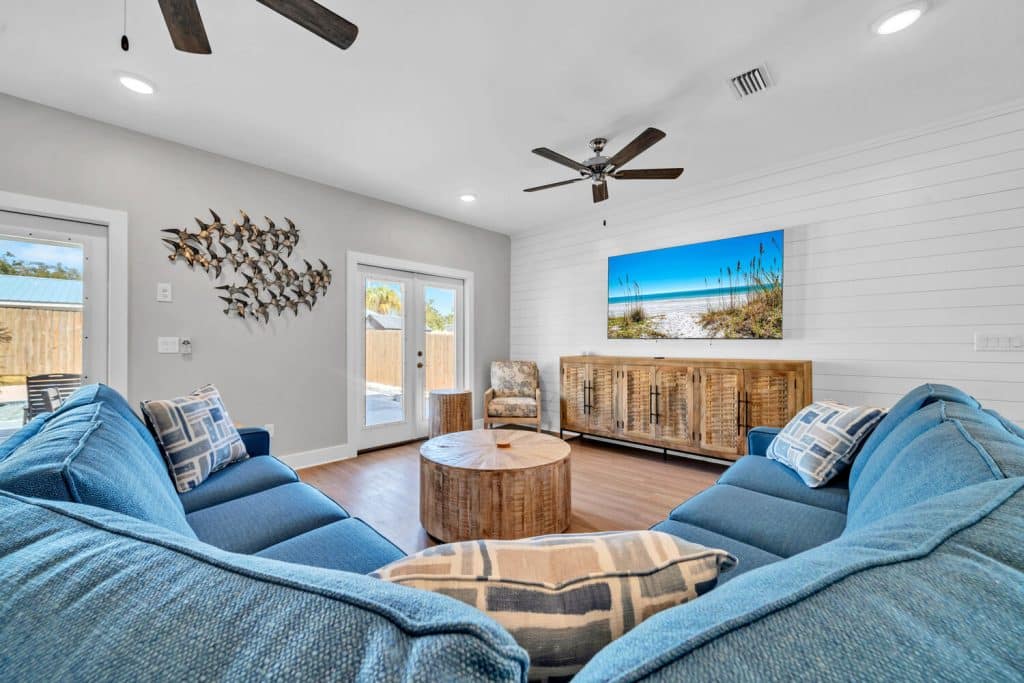 coastal designed living room with beachy white and blue accessories designed and decorated by Shore House Furniture in Panama City Beach Florida