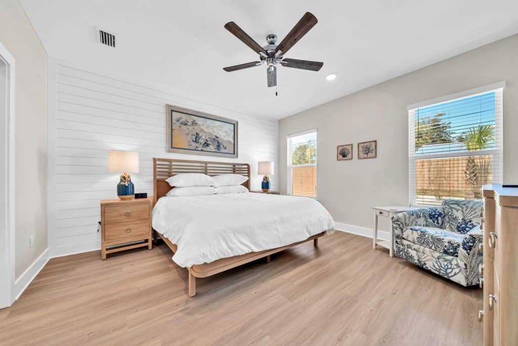 coastal designed bedroom with beachy white and floral accessories designed and decorated by Shore House Furniture in Panama City Beach Florida