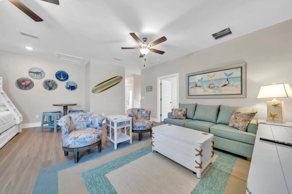 coastal designed sitting area with beachy white and floral accessories designed and decorated by Shore House Furniture in Panama City Beach Florida