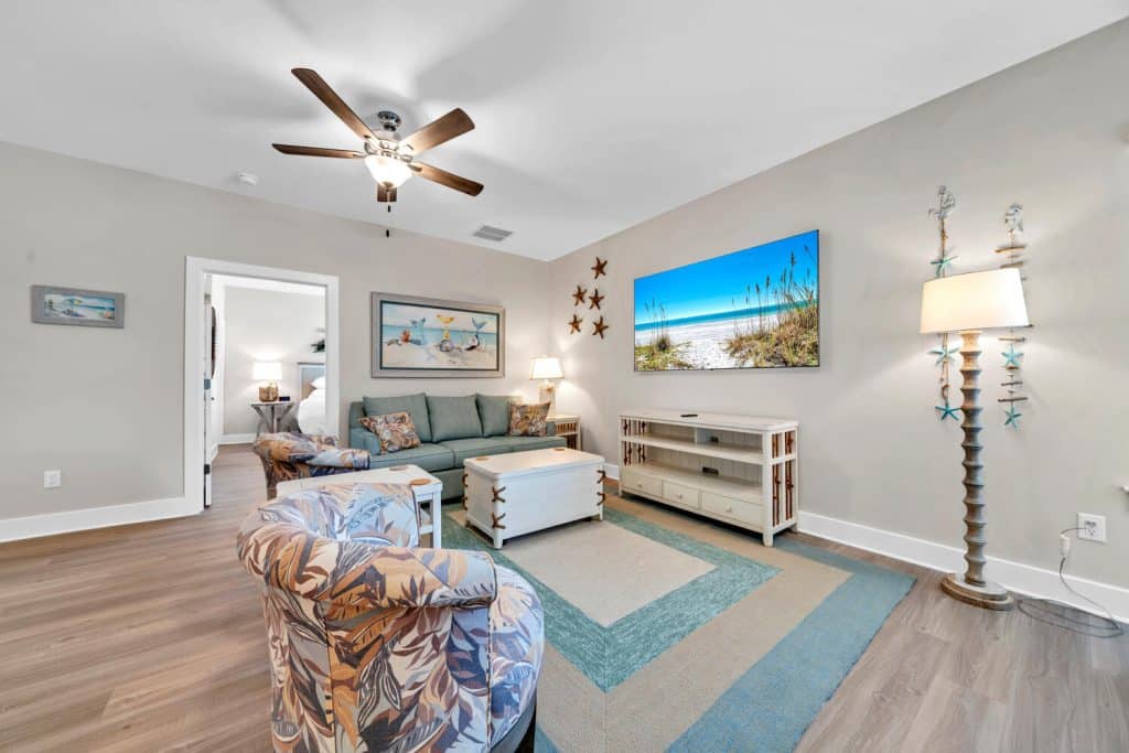 coastal designed sitting area with beachy white and floral accessories designed and decorated by Shore House Furniture in Panama City Beach Florida