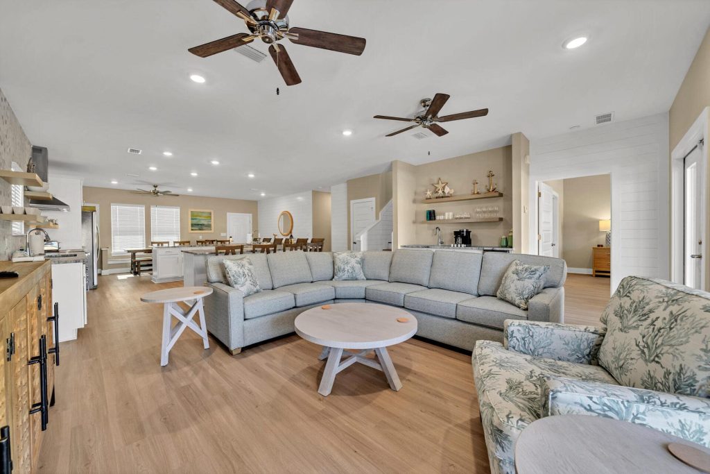 coastal designed living room and bar with beachy white and blue accessories designed and decorated by Shore House Furniture in Panama City Beach Florida