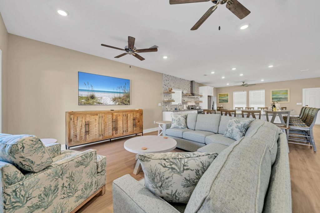 coastal designed living room and bar with beachy white and blue accessories designed and decorated by Shore House Furniture in Panama City Beach Florida