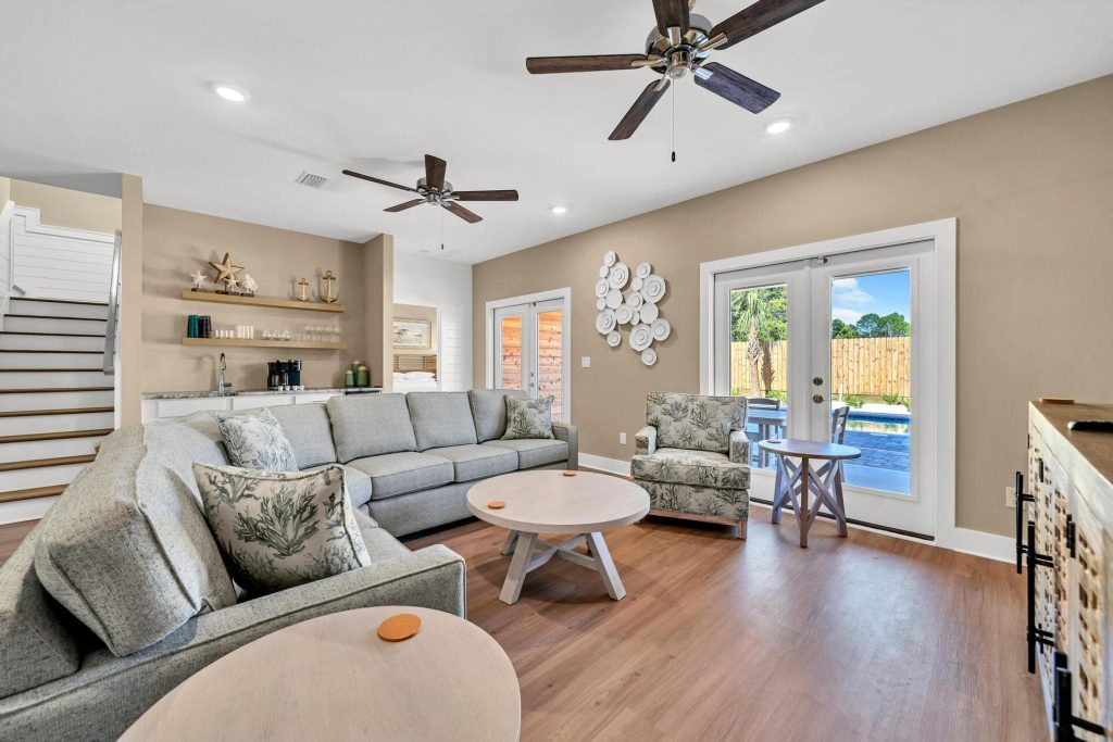 coastal designed living room and bar with beachy white and blue accessories designed and decorated by Shore House Furniture in Panama City Beach Florida