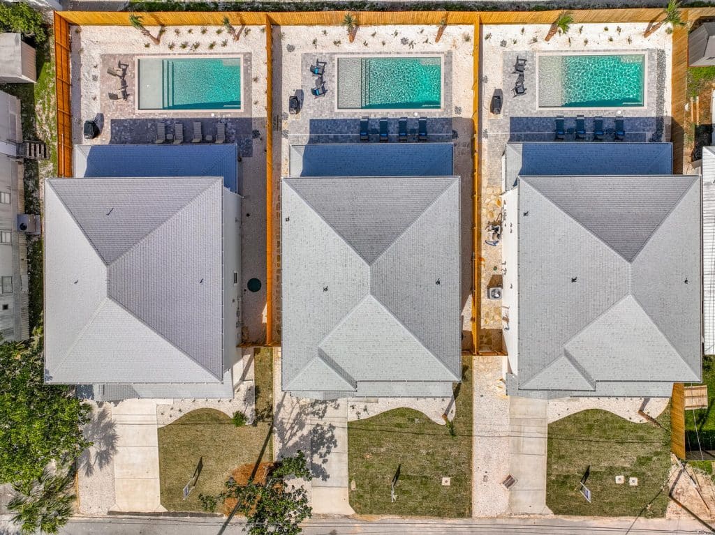 Ariel view of three coastal homes with pools in Panama City Beach