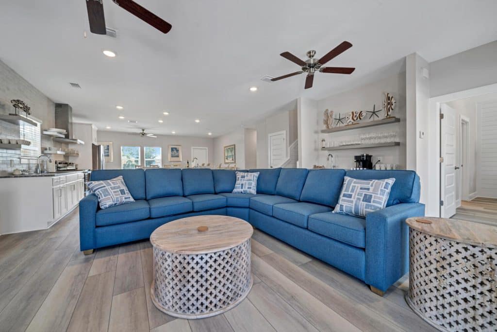 coastal designed living room with beachy white and dark blue accessories designed and decorated by Shore House Furniture in Panama City Beach Florida