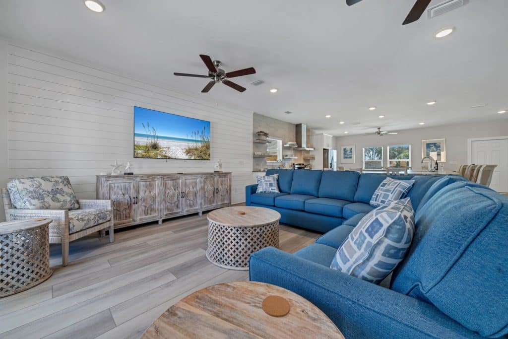 coastal designed living room with beachy white and dark blue accessories designed and decorated by Shore House Furniture in Panama City Beach Florida