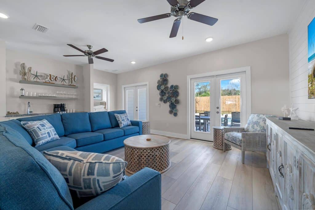 coastal designed living room with beachy white and dark blue accessories designed and decorated by Shore House Furniture in Panama City Beach Florida