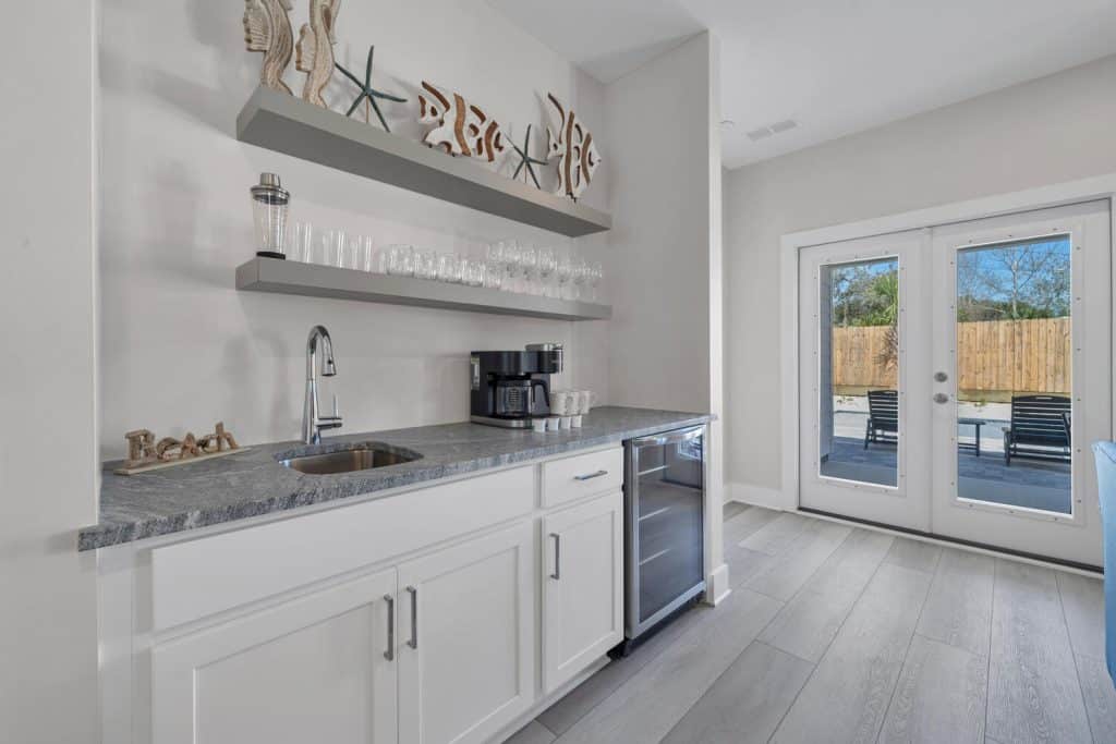 coastal designed breakfast nook with beachy white and teal accessories designed and decorated by Shore House Furniture in Panama City Beach Florida