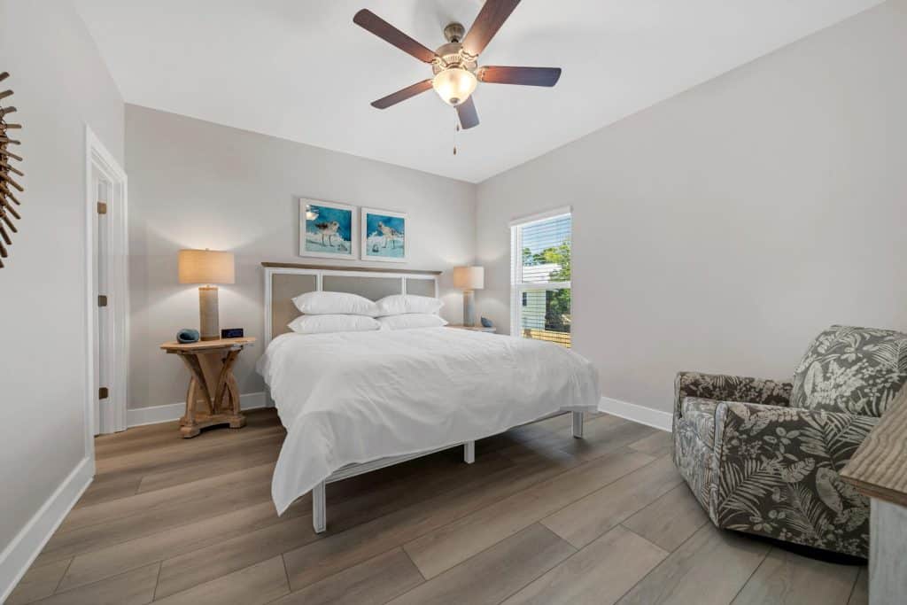 coastal designed bedroom with beachy white and teal accessories designed and decorated by Shore House Furniture in Panama City Beach Florida