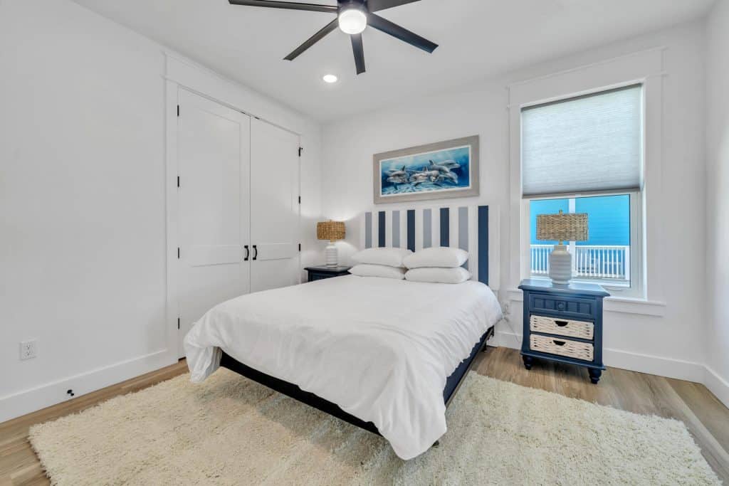 coastal designed guest bedroom with beachy white accessories designed and decorated by Shore House Furniture in Panama City Beach Florida