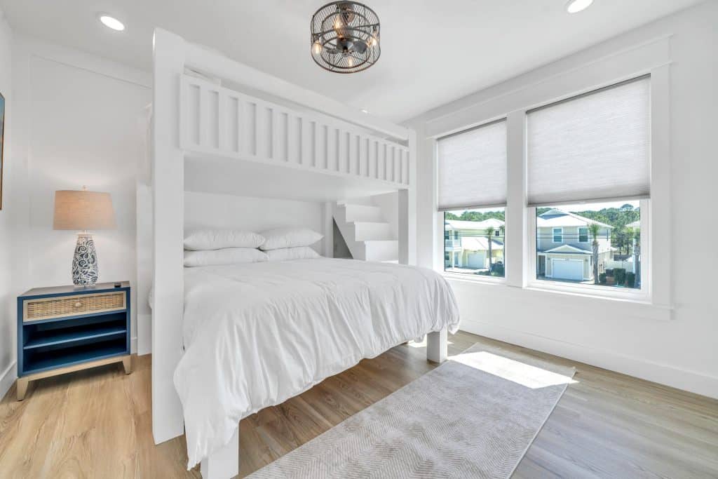 coastal designed guest bedroom with beachy white accessories designed and decorated by Shore House Furniture in Panama City Beach Florida
