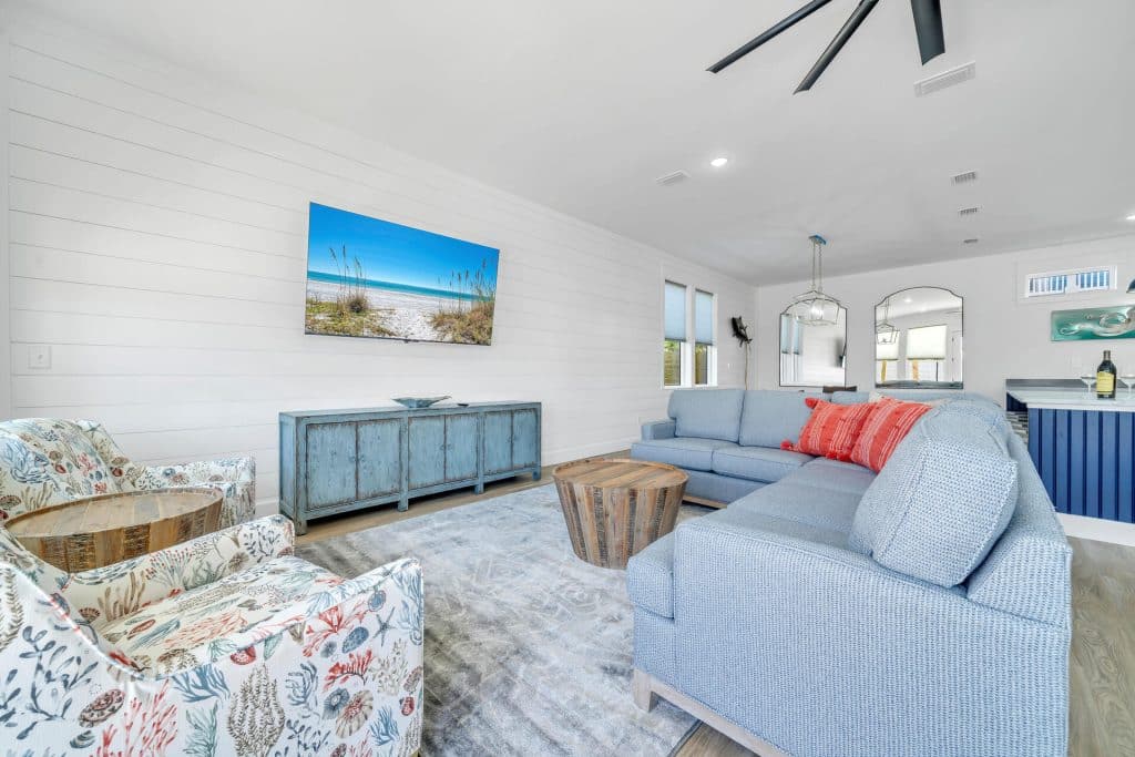 coastal designed living room area open floor plan with beachy white and blues accessories designed and decorated by Shore House Furniture in Panama City Beach Florida