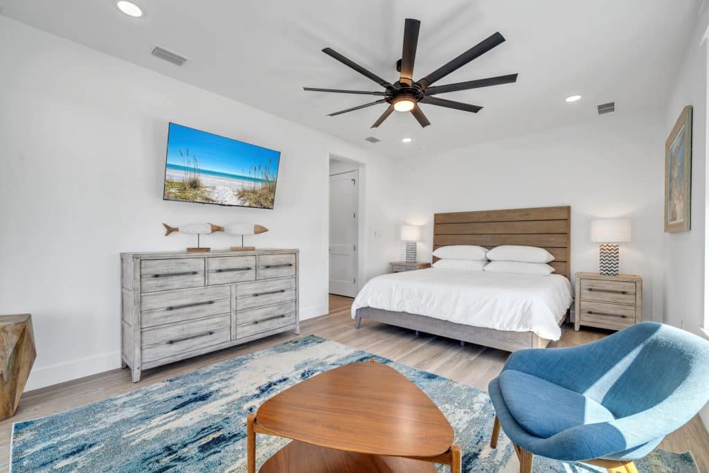 coastal designed master bedroom with beachy white and blue accessories designed and decorated by Shore House Furniture in Panama City Beach Florida