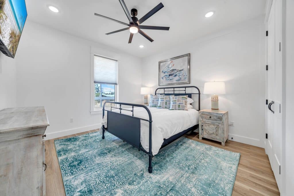 coastal designed guest bedroom with beachy white and blue accessories designed and decorated by Shore House Furniture in Panama City Beach Florida